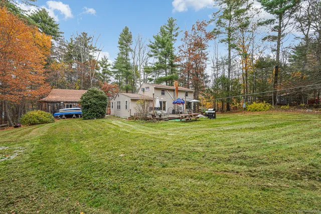 a view of a house with a big yard and palm trees