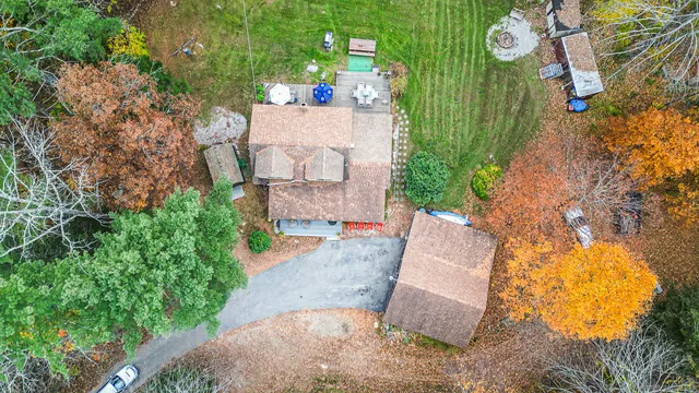 an aerial view of a house with a yard and trees