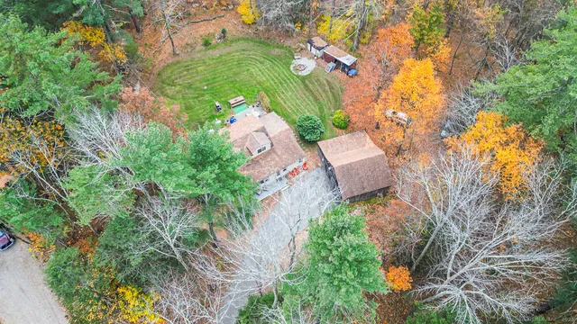 an aerial view of a house with a yard and garden