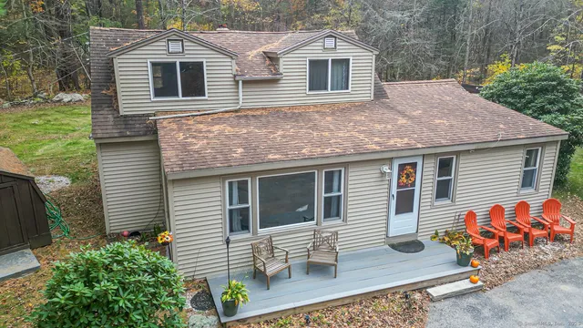 a view of a house with a yard and potted plants
