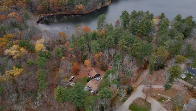 an aerial view of house with yard and outdoor seating
