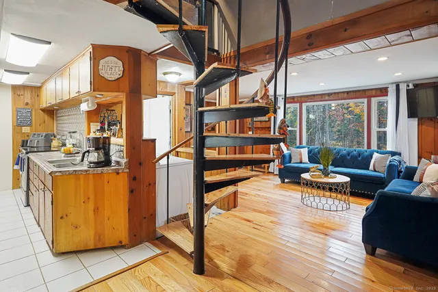 a living room with furniture a rug and a window