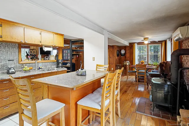a view of a kitchen with kitchen island granite countertop lots of counter top space and furniture