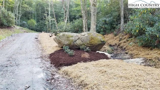 a view of a garden with lawn chairs