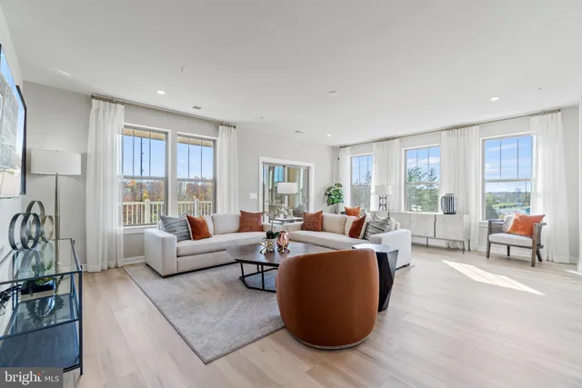a living room with furniture and a large window with outer view