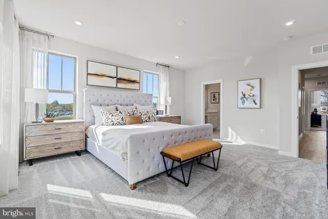 a bedroom with a bed and a view of kitchen