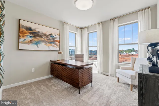 a living room with furniture and a painting on the wall