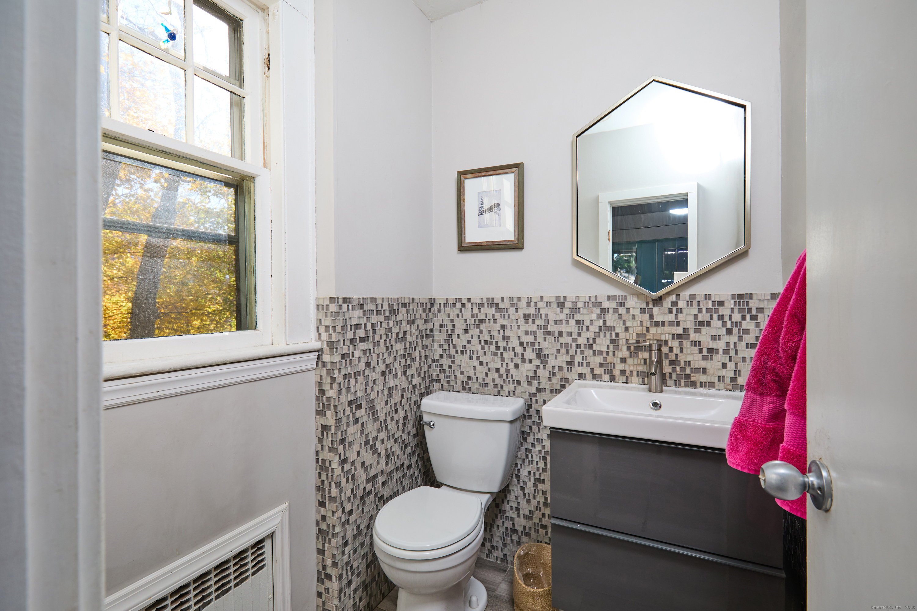 155 Moody Avenue Fairfield, CT 06825 - Photo 15 of 34 a bathroom with a toilet a sink and a mirror