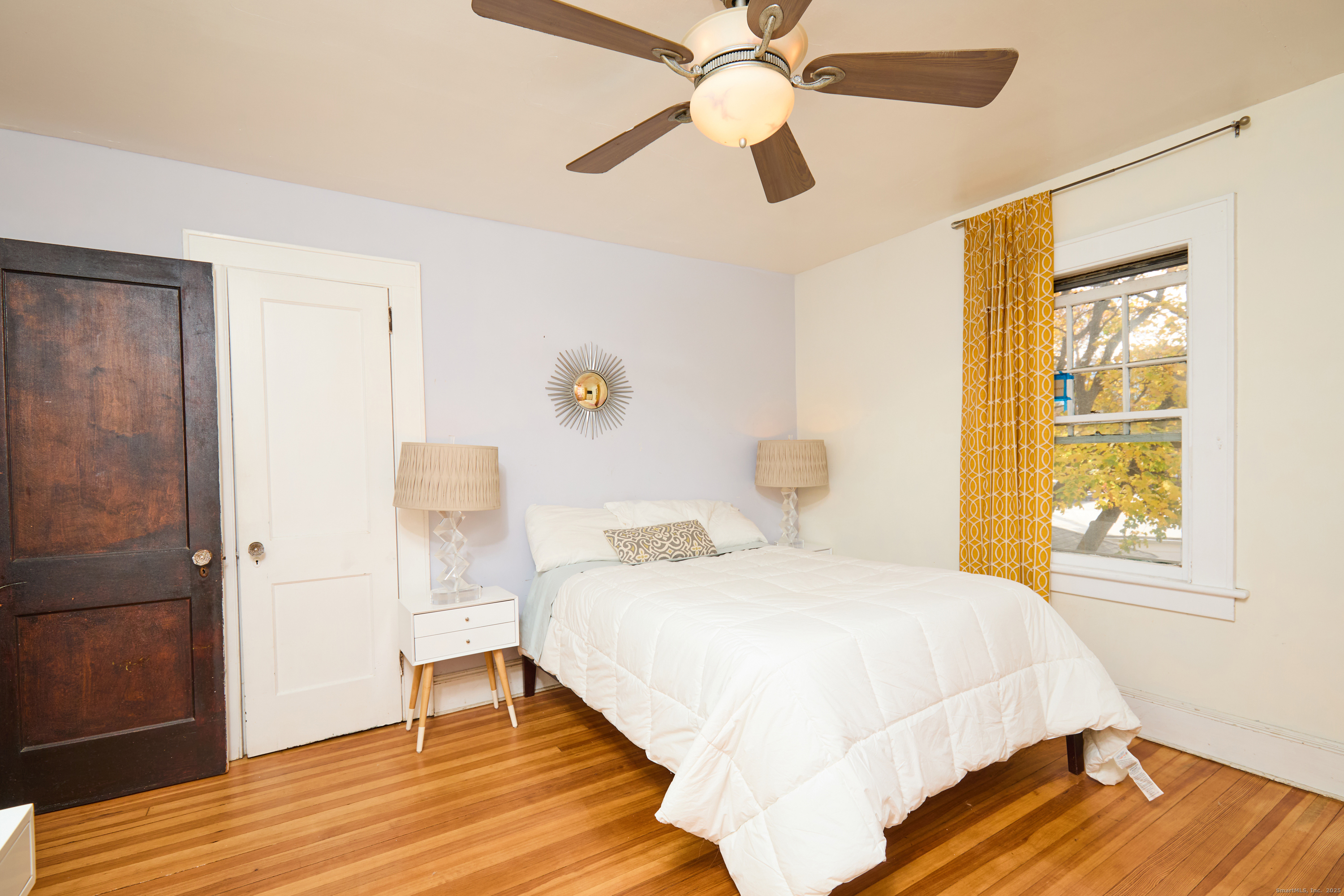 155 Moody Avenue Fairfield, CT 06825 - Photo 20 of 34 a bedroom with a bed and wooden floor