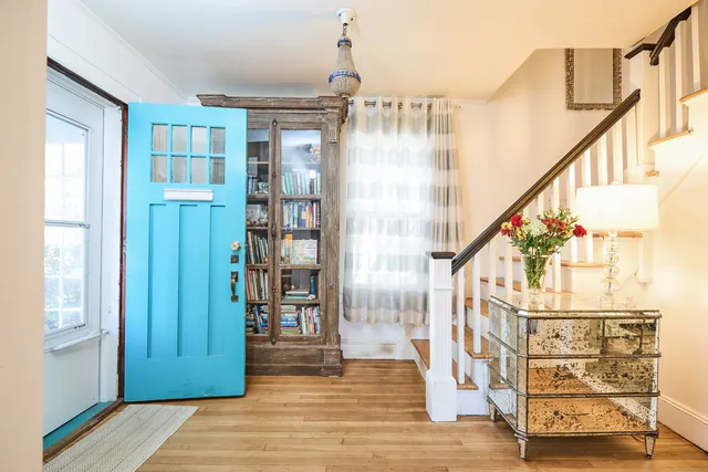 a view of entryway and hall with wooden floor