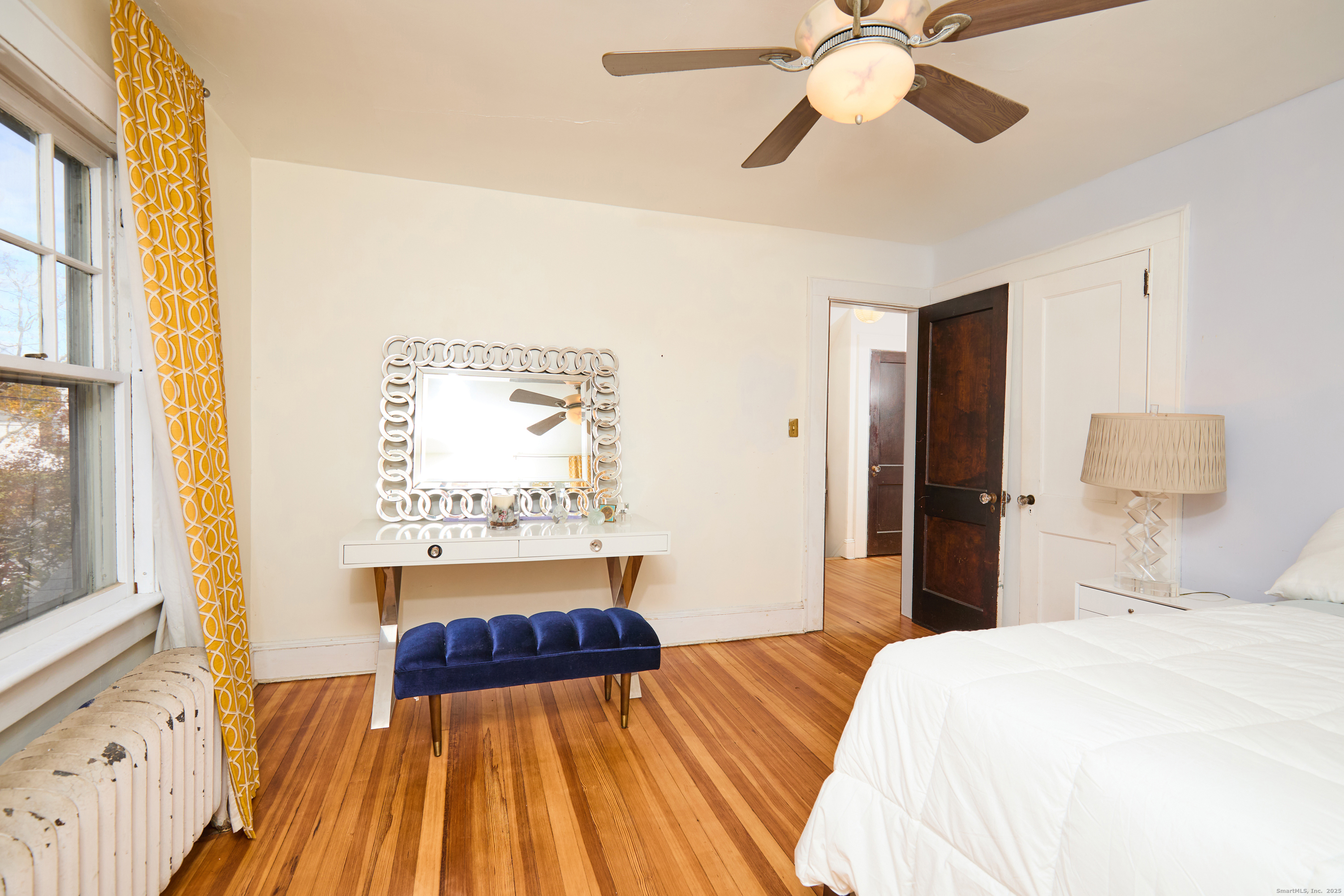 155 Moody Avenue Fairfield, CT 06825 - Photo 21 of 34 a bedroom with a bed and a chandelier