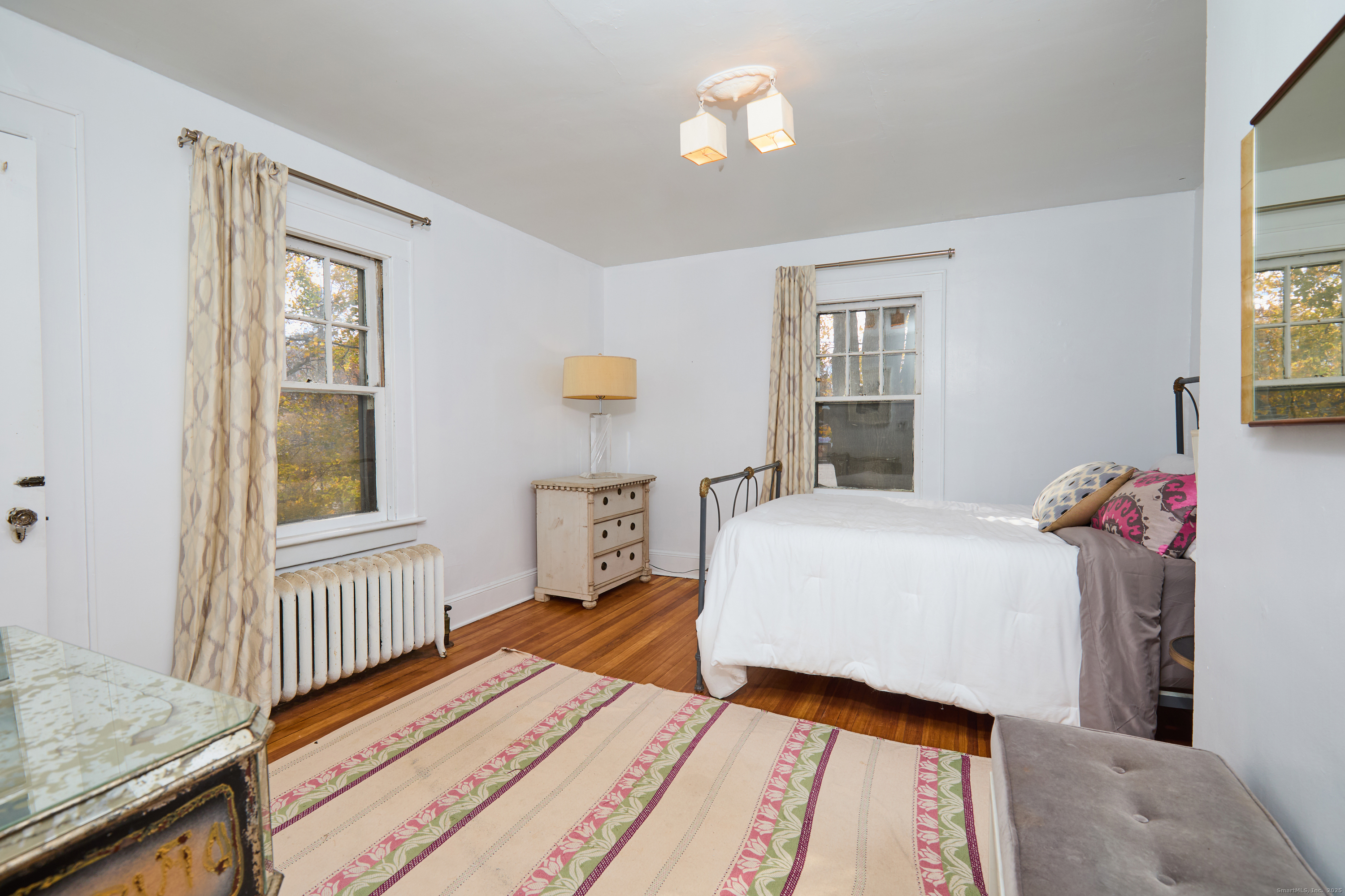 155 Moody Avenue Fairfield, CT 06825 - Photo 22 of 34 a bedroom with a bed and wooden floor