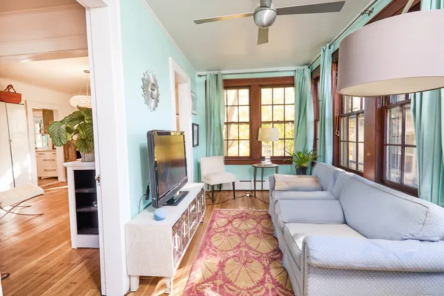 a living room with furniture fireplace and a flat screen tv