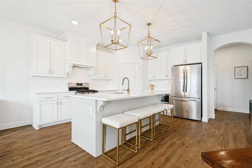 9424 Wildcat Ridge Godley, TX 76044 - Photo 9 of 25 a kitchen with wooden cabinets and stainless steel appliances