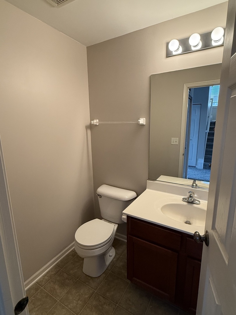 1403 Fabiola Court South Minooka, IL 60447 - Photo 13 of 30 a bathroom with a sink a toilet and a mirror