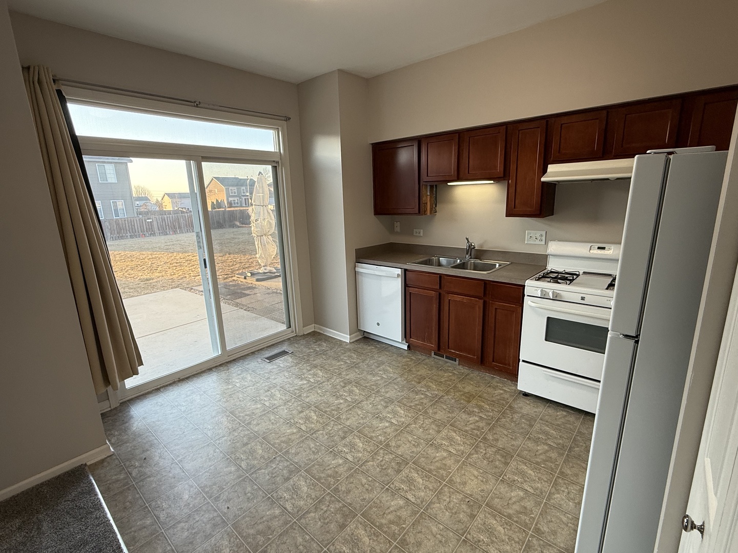 1403 Fabiola Court South Minooka, IL 60447 - Photo 10 of 30 a kitchen with stainless steel appliances granite countertop a stove a refrigerator and a sink