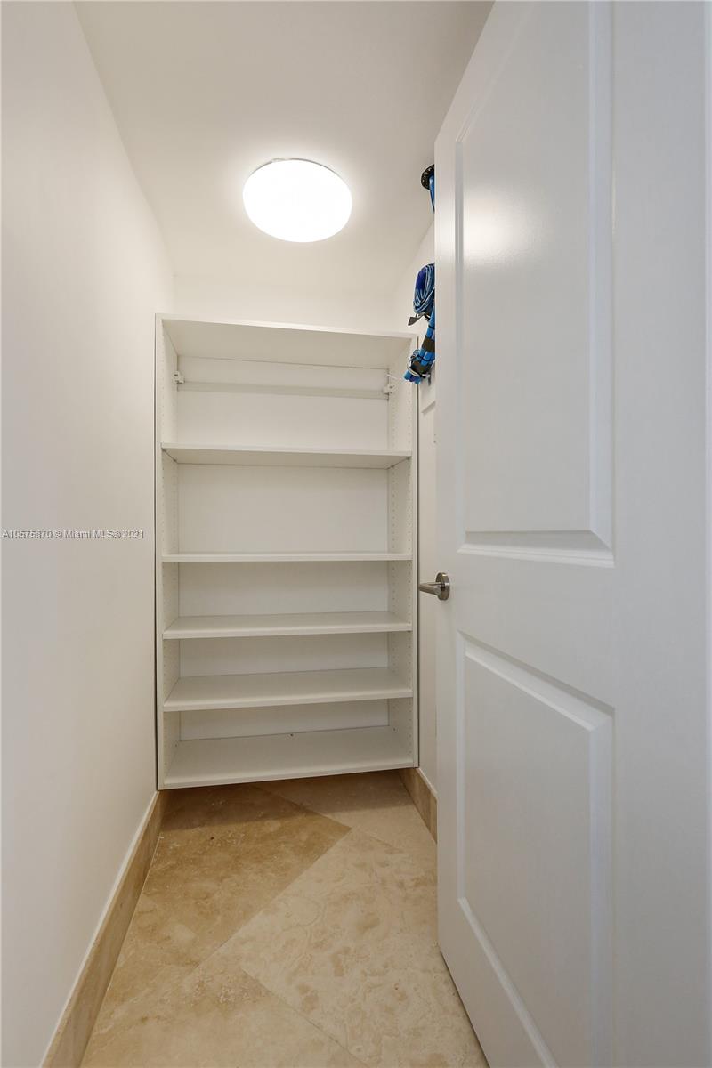 8925 Collins Avenue, Unit 9B Surfside, FL 33154 - Photo 12 of 46 a view of walk in closet with empty racks
