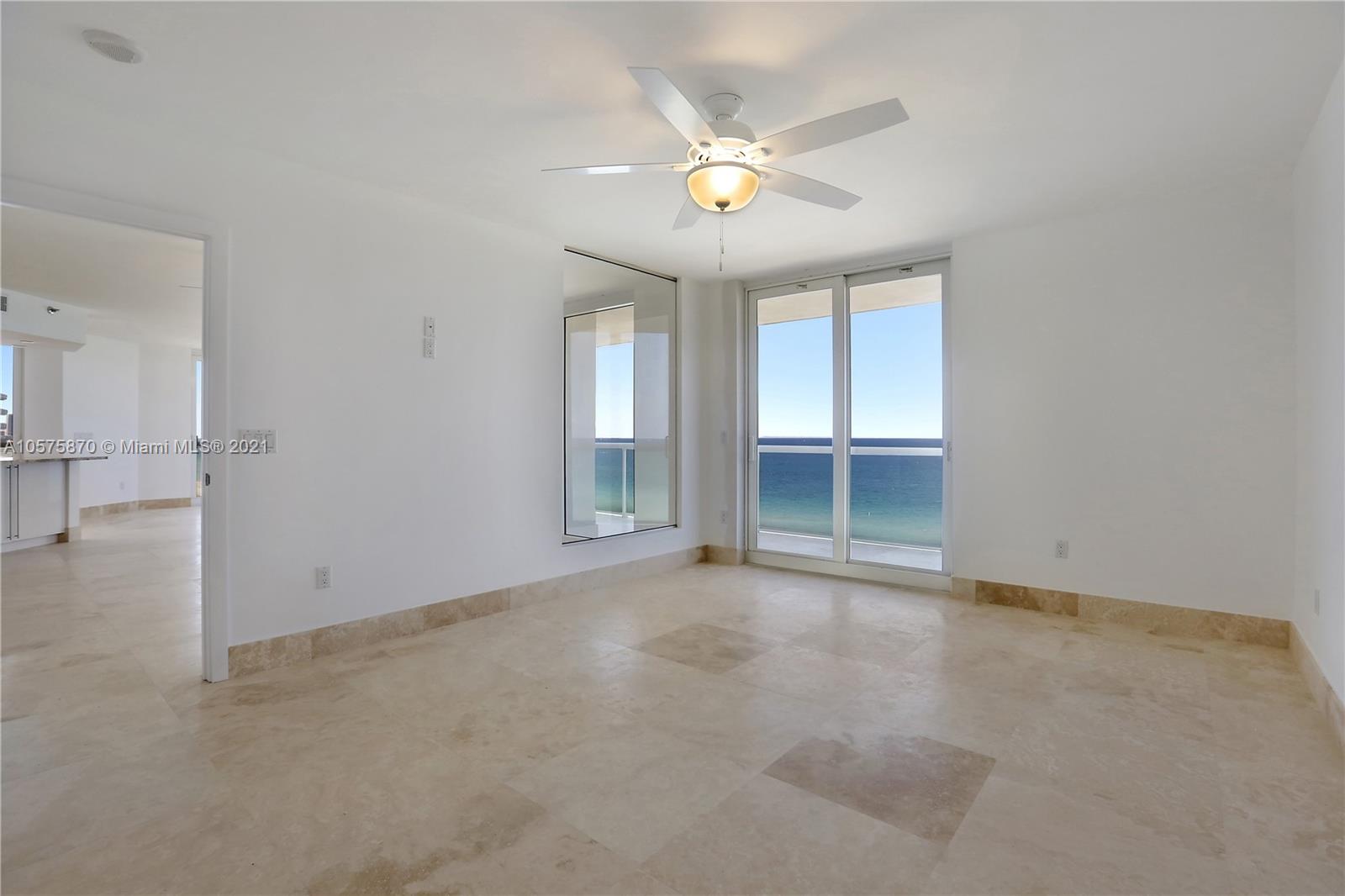 8925 Collins Avenue, Unit 9B Surfside, FL 33154 - Photo 14 of 46 an empty room with windows and fan