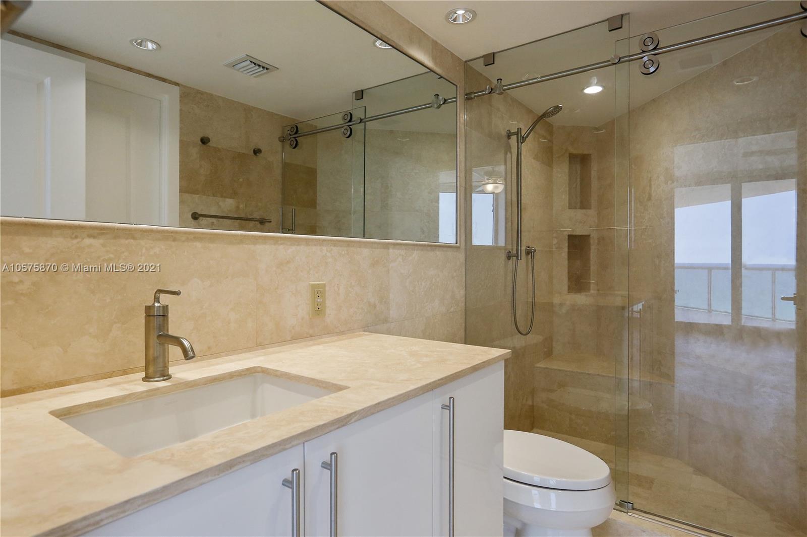 8925 Collins Avenue, Unit 9B Surfside, FL 33154 - Photo 21 of 46 a bathroom with a sink a toilet and shower