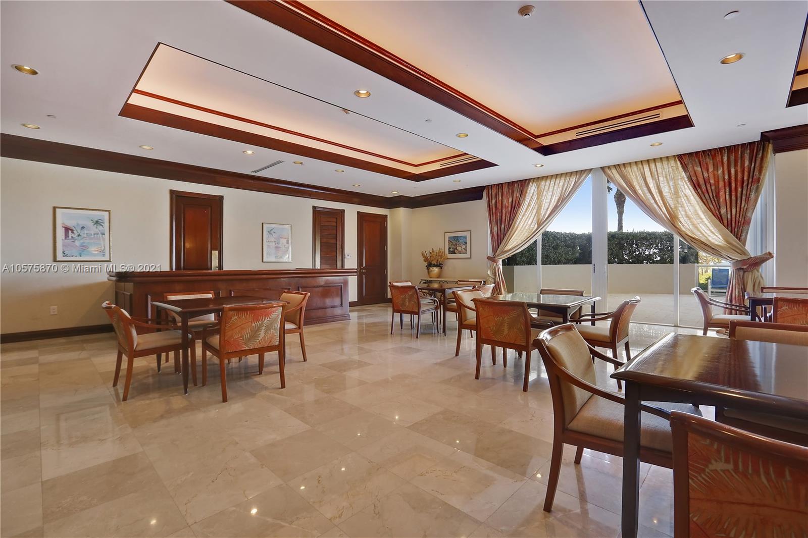 8925 Collins Avenue, Unit 9B Surfside, FL 33154 - Photo 33 of 46 a dining hall with furniture a window and a fireplace