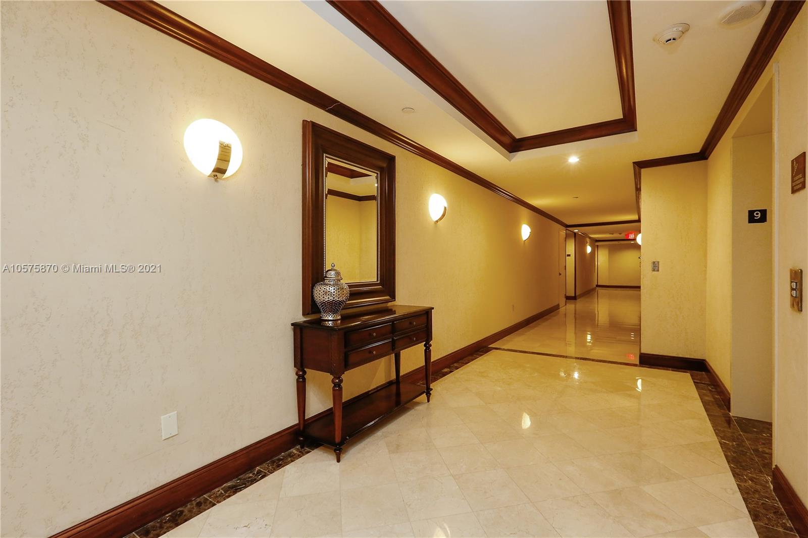 8925 Collins Avenue, Unit 9B Surfside, FL 33154 - Photo 37 of 46 a view of a hallway with paintings on the wall