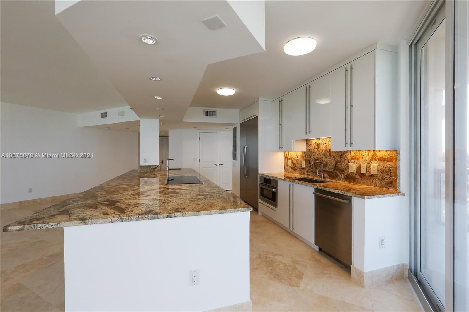 8925 Collins Avenue, Unit 9B Surfside, FL 33154 - Photo 6 of 46 a kitchen with stainless steel appliances granite countertop cabinets and granite counter tops