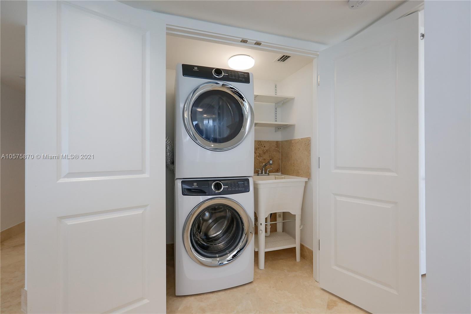 8925 Collins Avenue, Unit 9B Surfside, FL 33154 - Photo 10 of 46 a utility room with dryer and washer