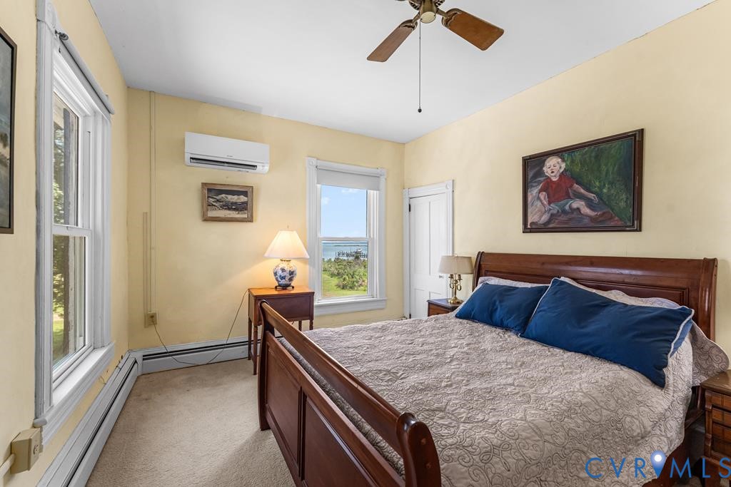 2414 Windmill Point Road White Stone, VA 22578 - Photo 33 of 72 a bedroom with a bed and a painting on the wall