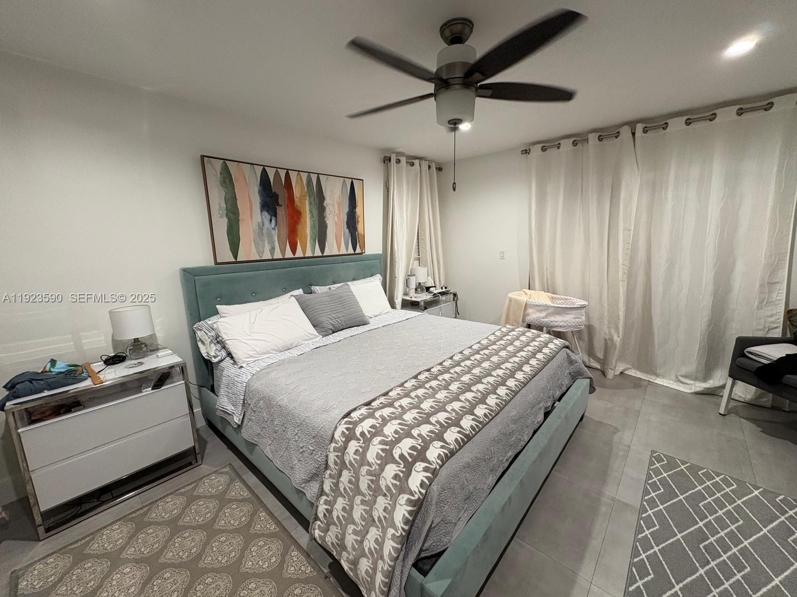 7119 Southwest 105th Court Miami, FL 33173 - Photo 11 of 19 a bedroom with a bed and a tv