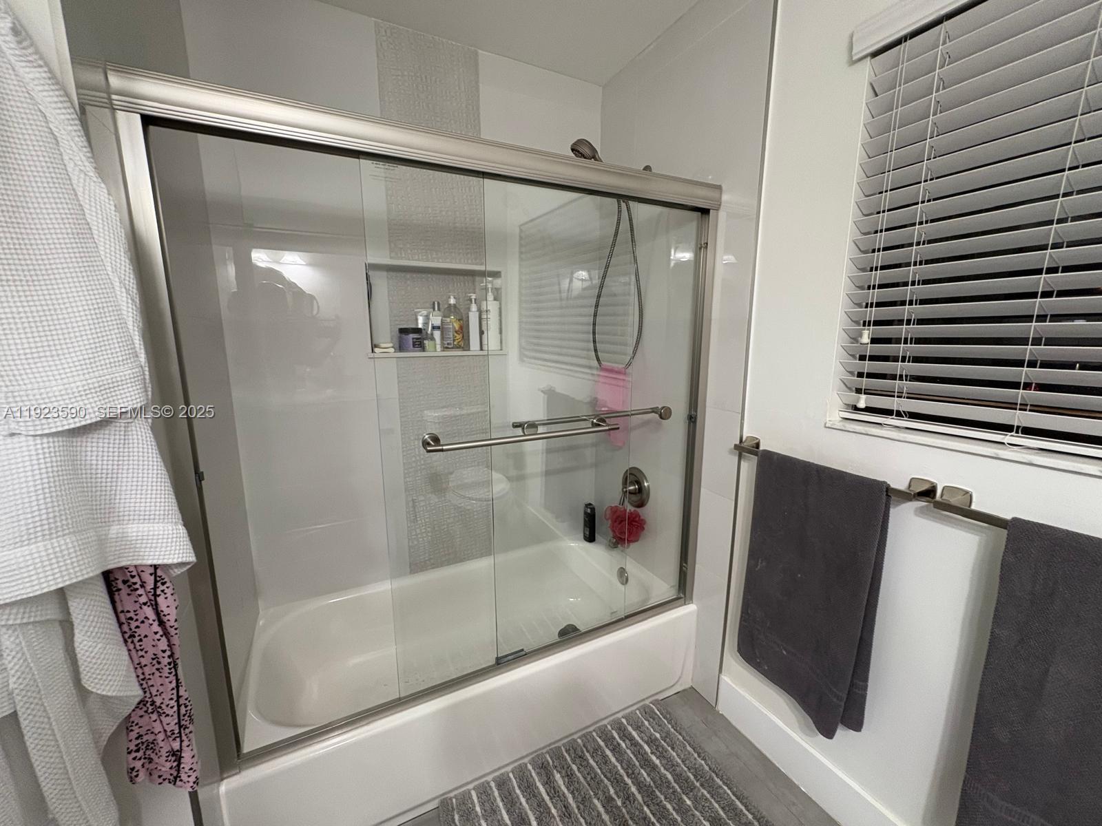7119 Southwest 105th Court Miami, FL 33173 - Photo 15 of 19 a bathroom with a bathtub and a shower