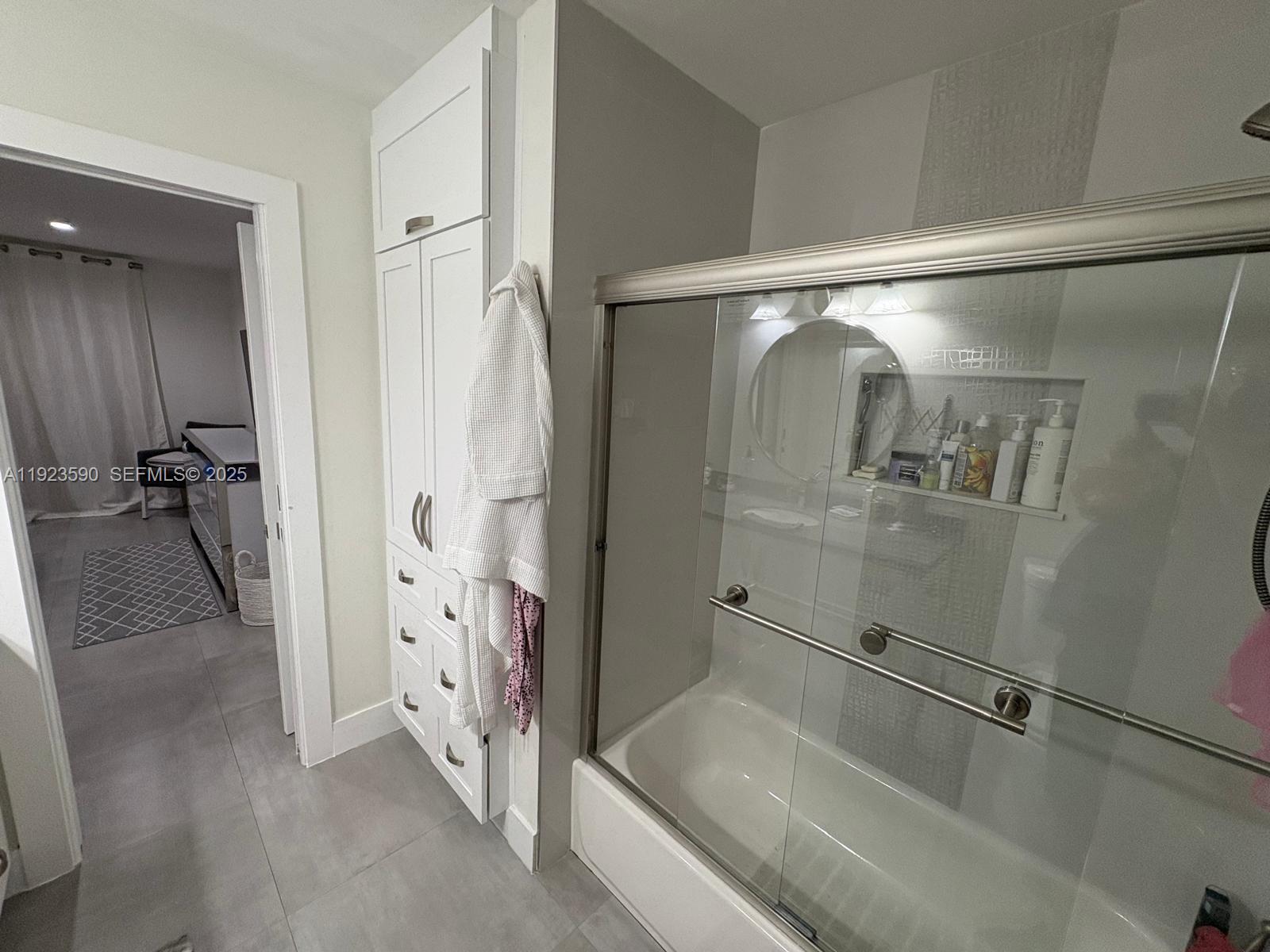 7119 Southwest 105th Court Miami, FL 33173 - Photo 16 of 19 a bathroom with a tub and a shower