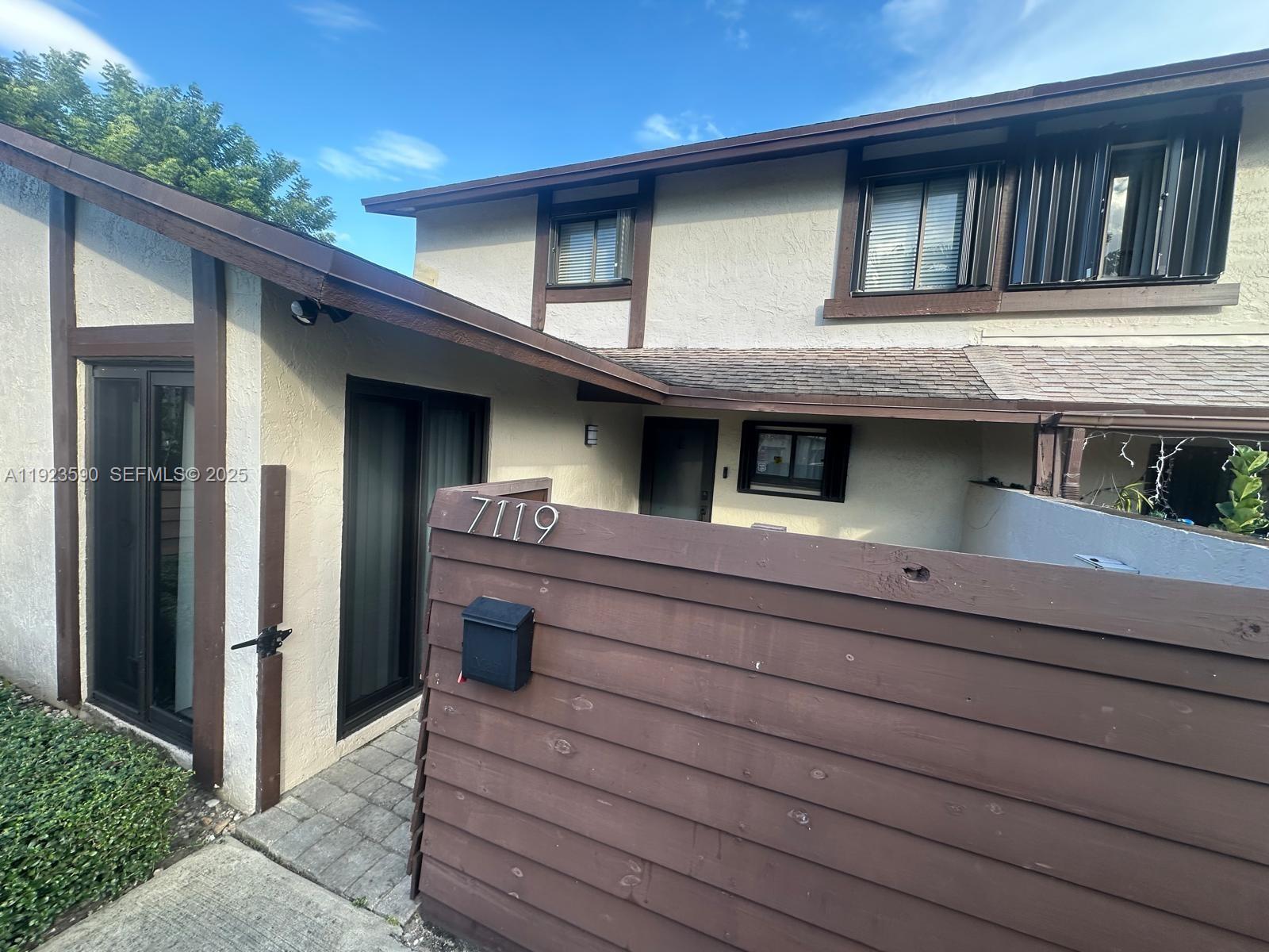 7119 Southwest 105th Court Miami, FL 33173 - Photo 2 of 19 a view of brick house with large windows