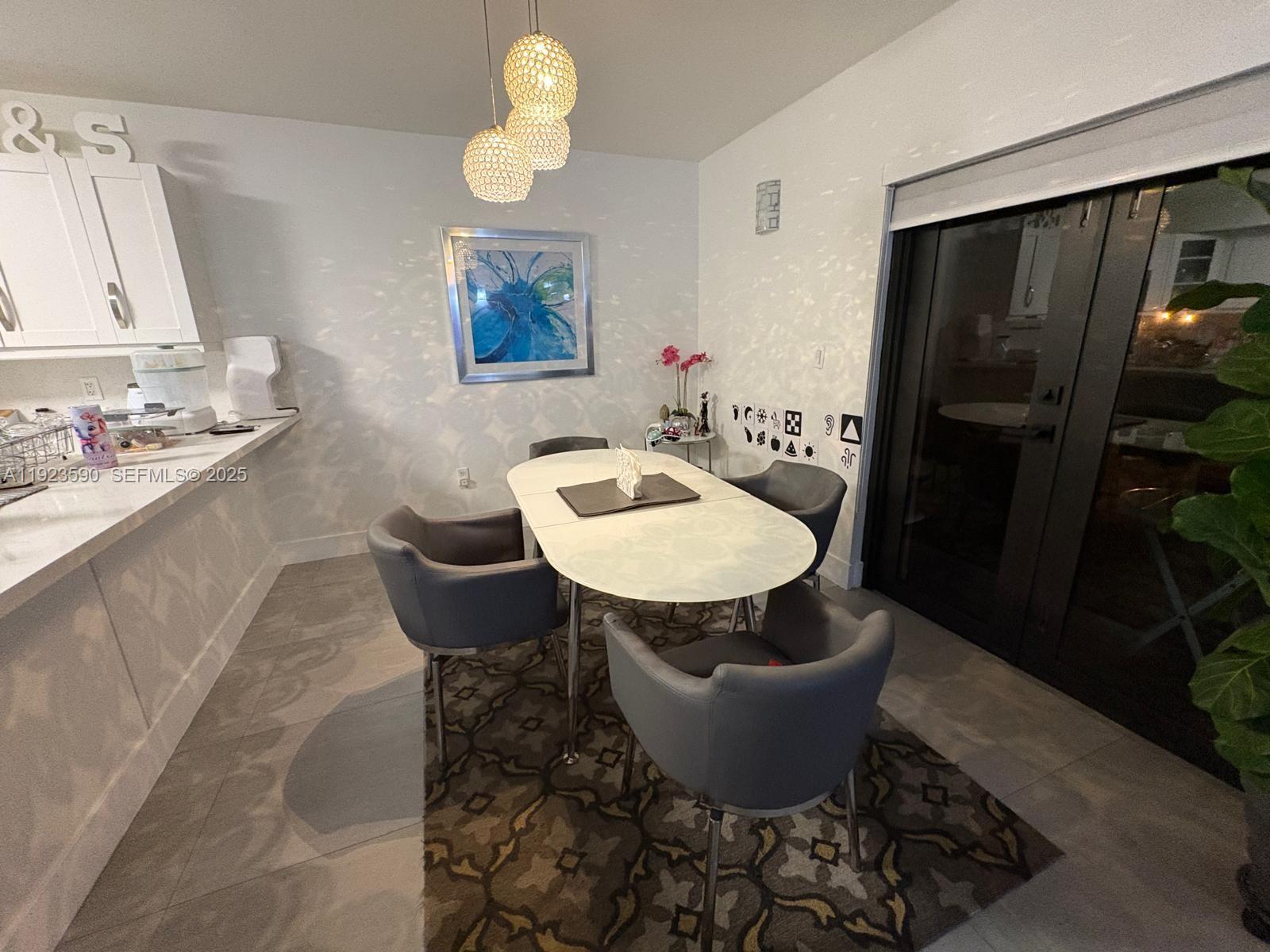 7119 Southwest 105th Court Miami, FL 33173 - Photo 5 of 19 a dining room with furniture and wooden floor