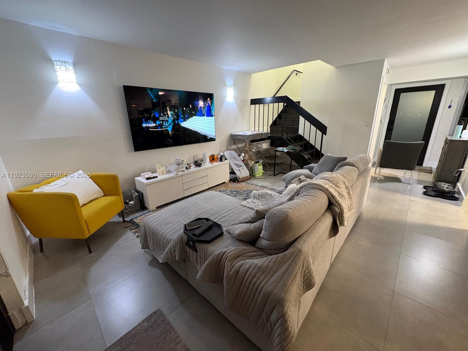 7119 Southwest 105th Court Miami, FL 33173 - Photo 7 of 19 a living room with furniture and a flat screen tv