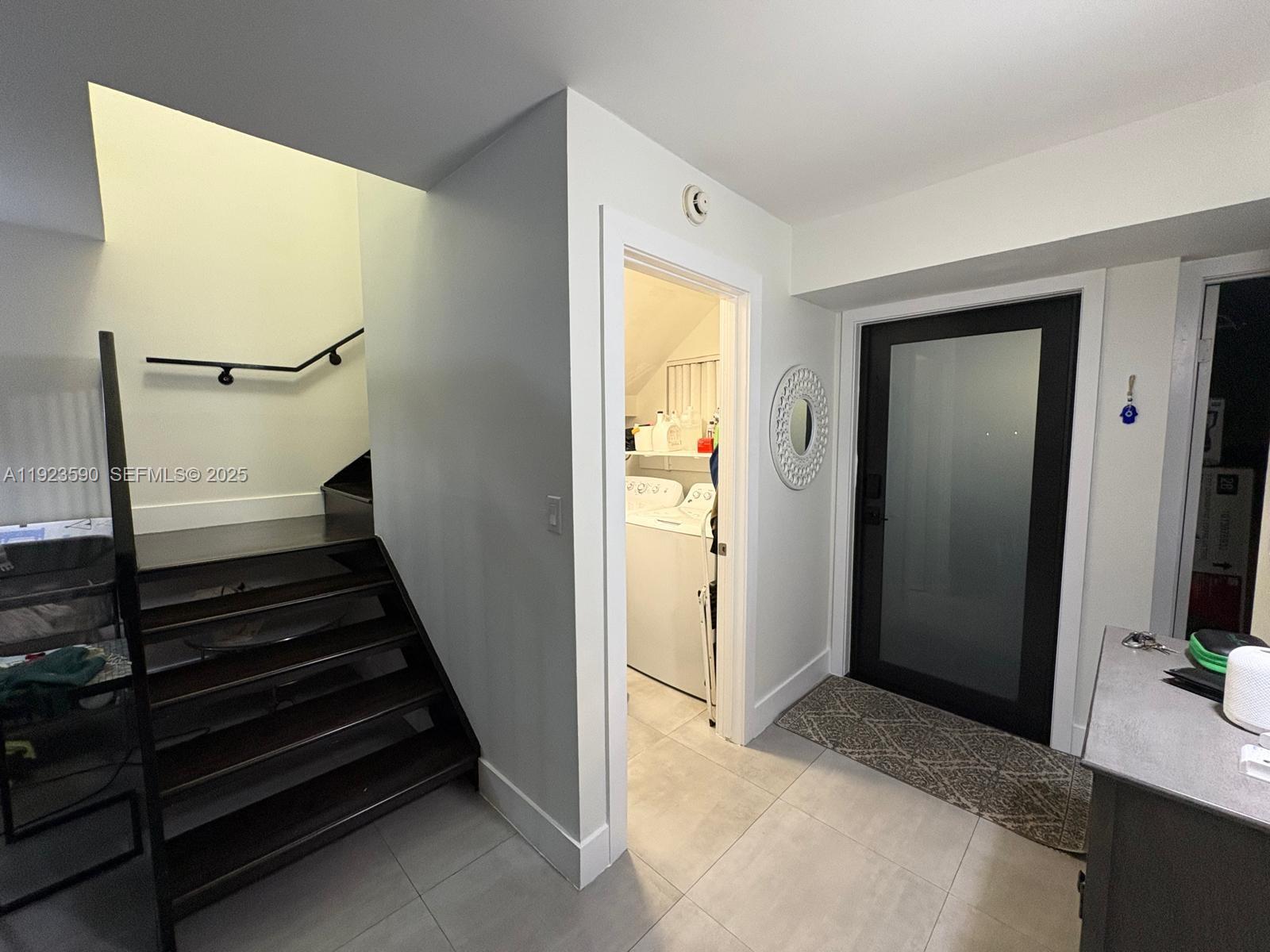 7119 Southwest 105th Court Miami, FL 33173 - Photo 8 of 19 a view of a hallway with wooden floor and staircase