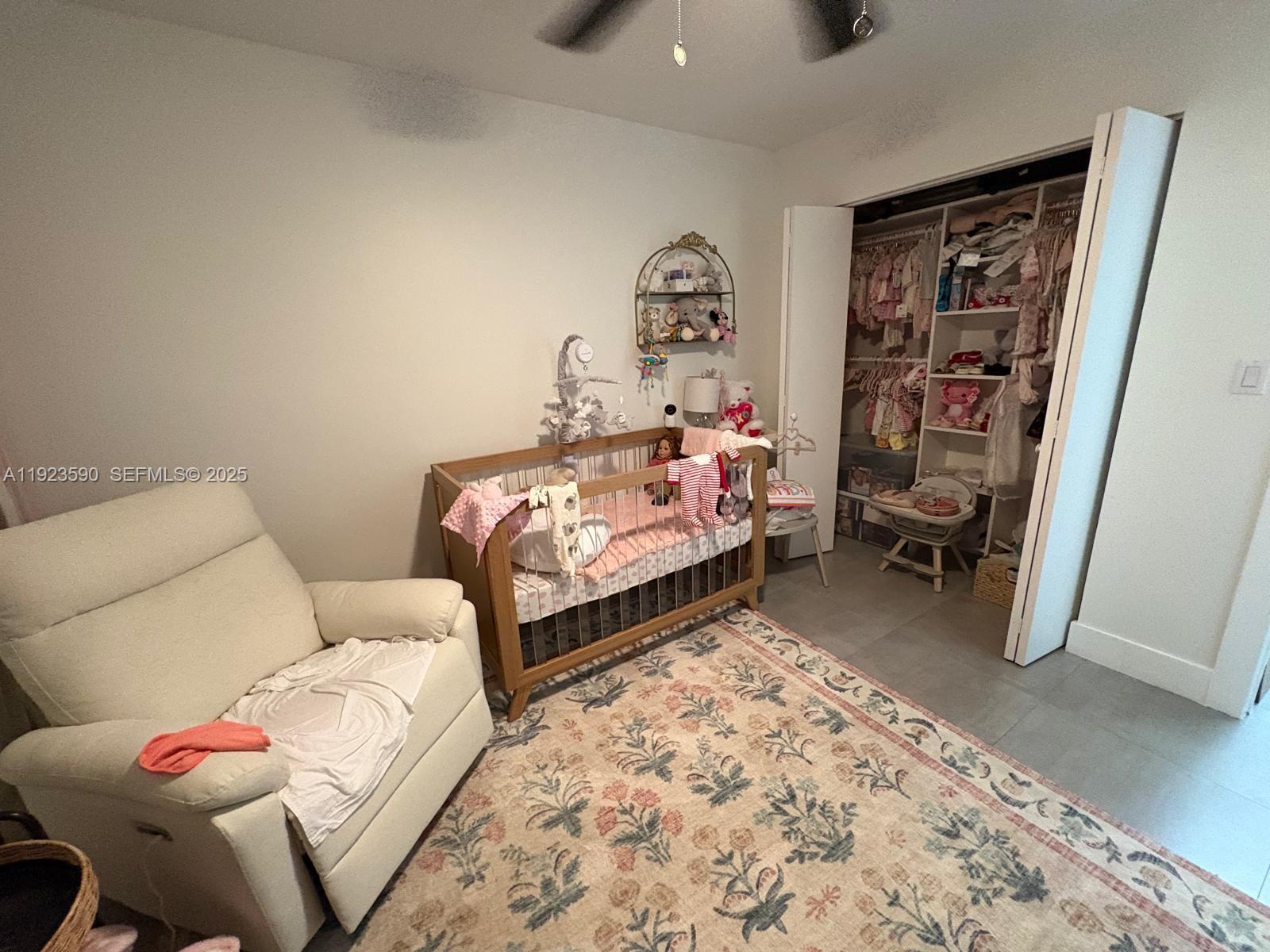 7119 Southwest 105th Court Miami, FL 33173 - Photo 10 of 19 a bed room with a bed and a chair