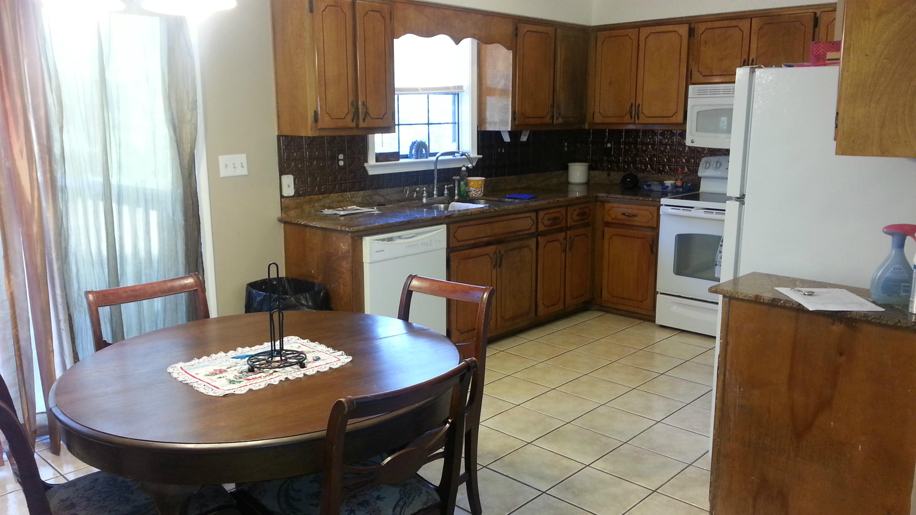 348 John King Road Crestview, FL 32539 - Photo 5 of 19 a kitchen with a table chairs stove and refrigerator