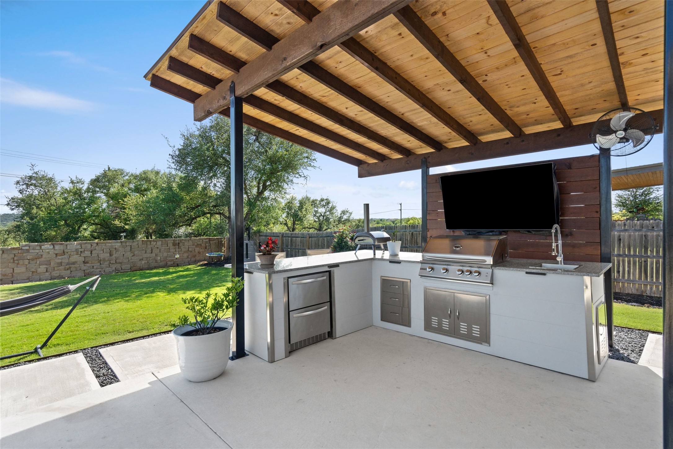 162 Lunar Loop Austin, TX 78737 - Photo 29 of 40 a view of a kitchen with a flat screen tv and a fireplace