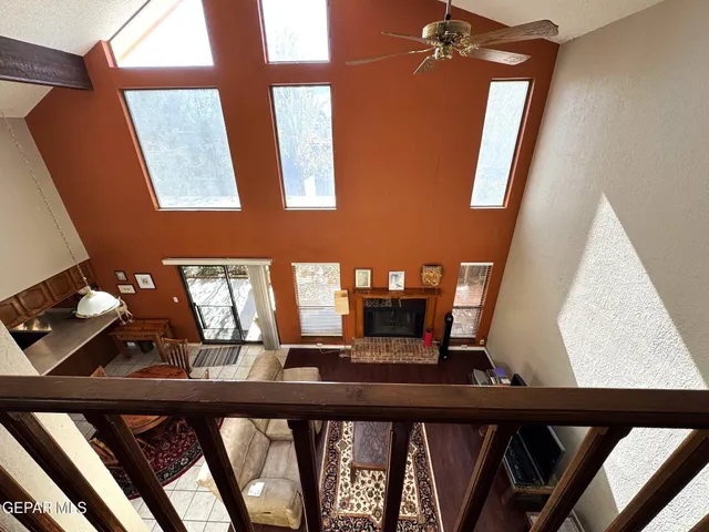 a view of a workspace with furniture and a book shelf