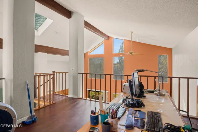 a dining room with furniture a kitchen view and chandelier