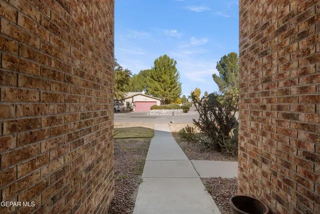 a living room with fireplace furniture and a large window