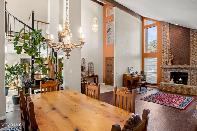 a view of a dining room with furniture a chandelier and wooden floor