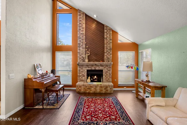 a living room with furniture a fireplace and a flat screen tv