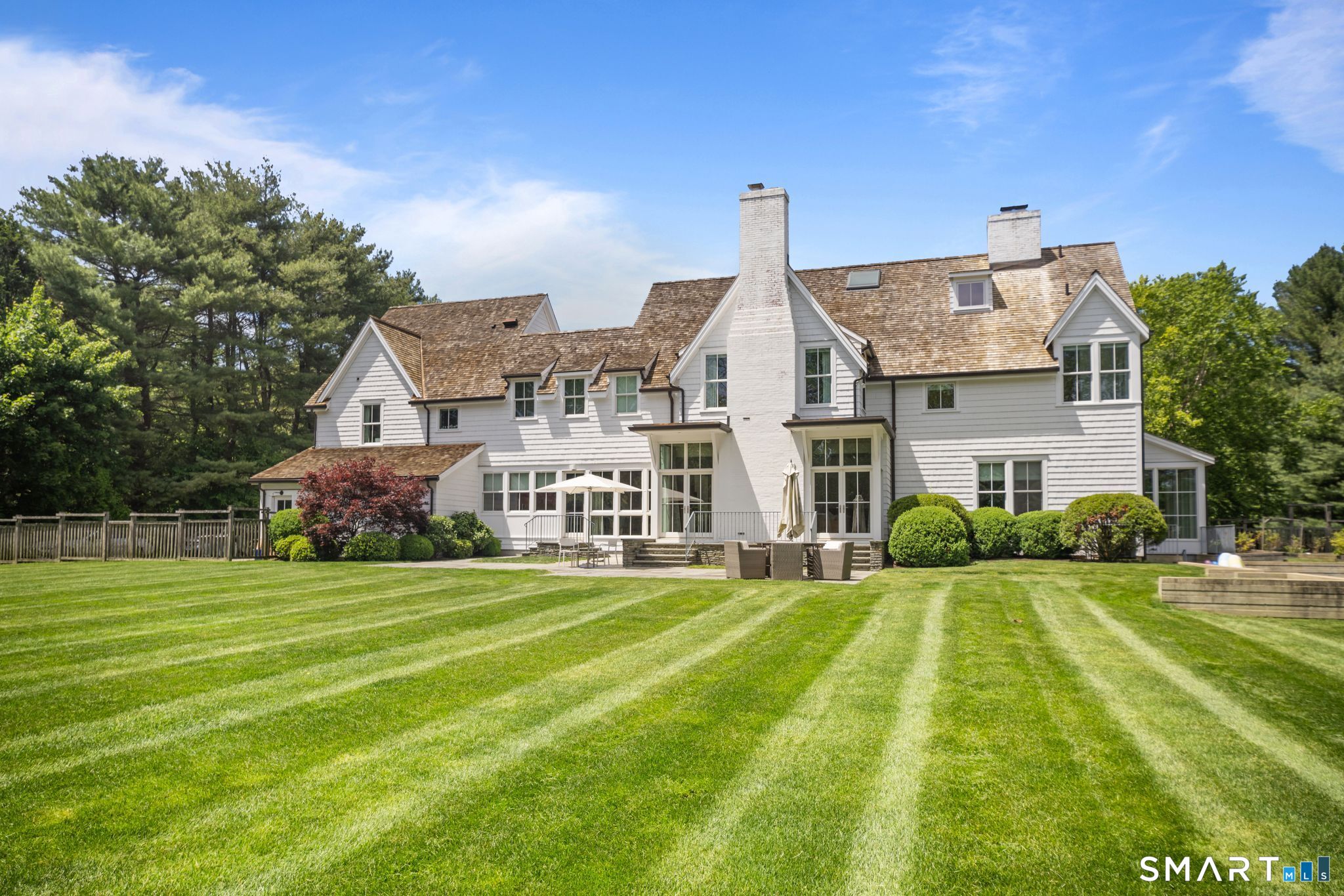 5 West Branch Road Weston, CT 06883 - Photo 4 of 40 a view of a big house with a big yard and large trees