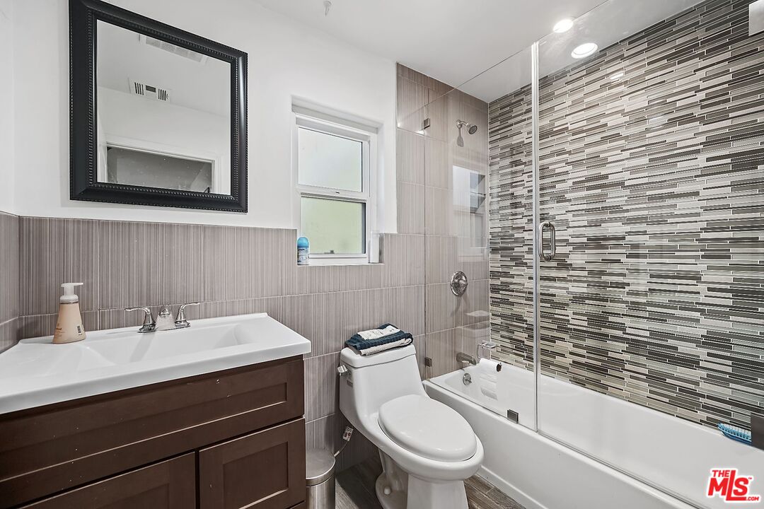 1945 Summit Avenue Pasadena, CA 91103 - Photo 12 of 15 a bathroom with a sink a toilet and shower