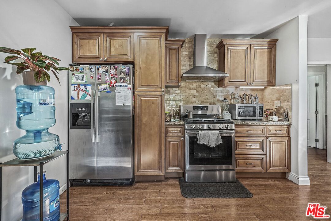1945 Summit Avenue Pasadena, CA 91103 - Photo 8 of 15 a kitchen with stainless steel appliances granite countertop a refrigerator and a stove