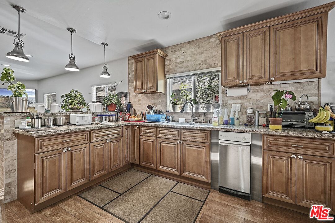 1945 Summit Avenue Pasadena, CA 91103 - Photo 9 of 15 a kitchen with stainless steel appliances granite countertop a sink and cabinets