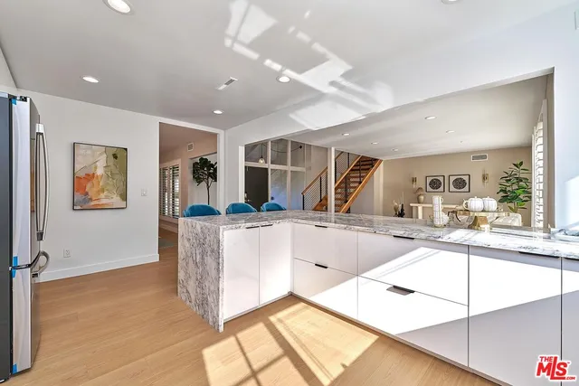 a bathroom with a granite countertop sink a toilet and a shower