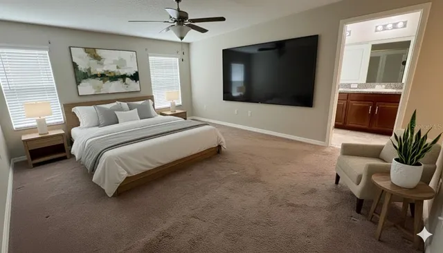 a spacious bedroom with a large bed and a flat screen tv