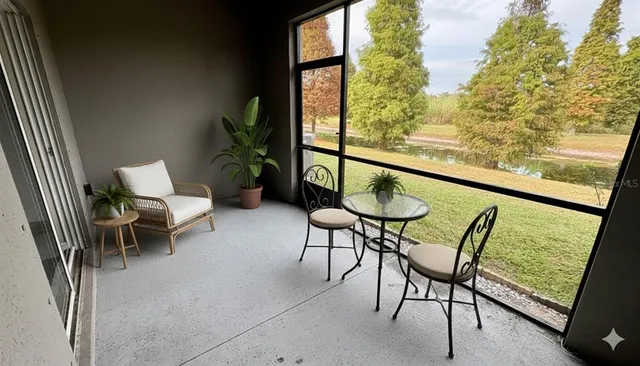 a balcony with chairs and a table